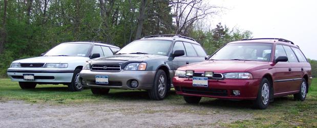 Three subaru's. White 1994, Green 2000, Red 1996